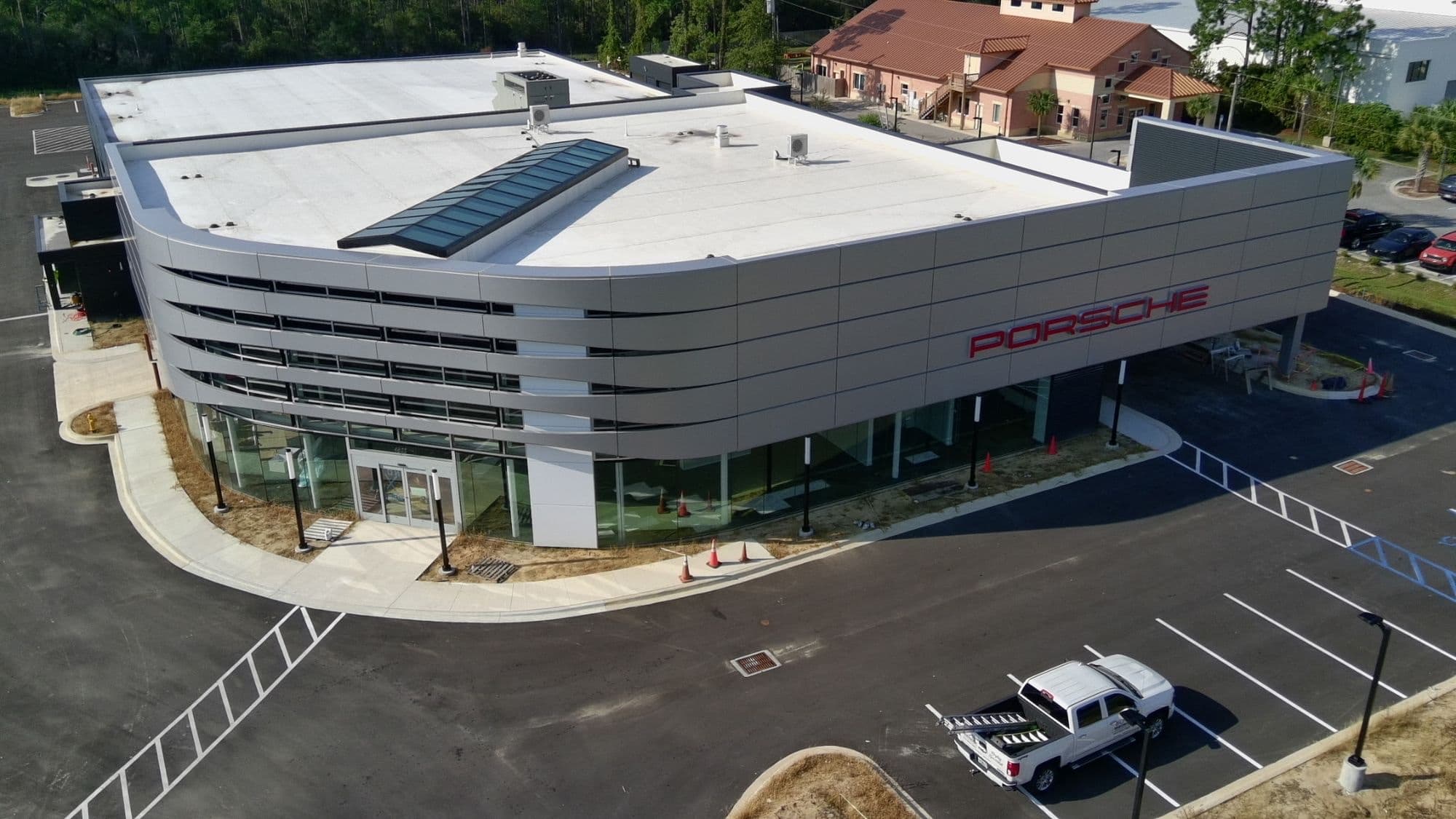 Aerial view of a new Porsche dealership built from the ground up by Whitrock Associates, Northwest Florida commercial contractor