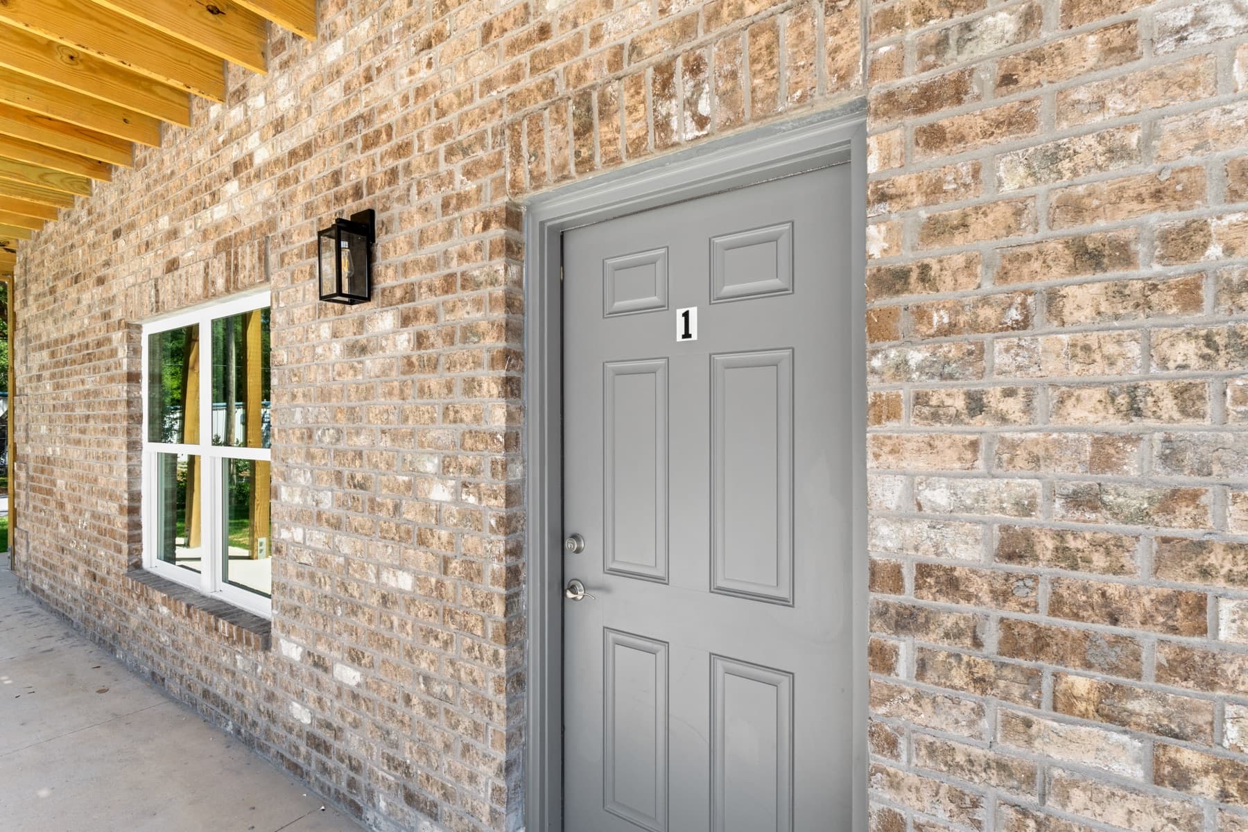 Brick veneer and unit entry door detail on a new apartment building built by Whitrock Associates, Northwest Florida commercial contractor