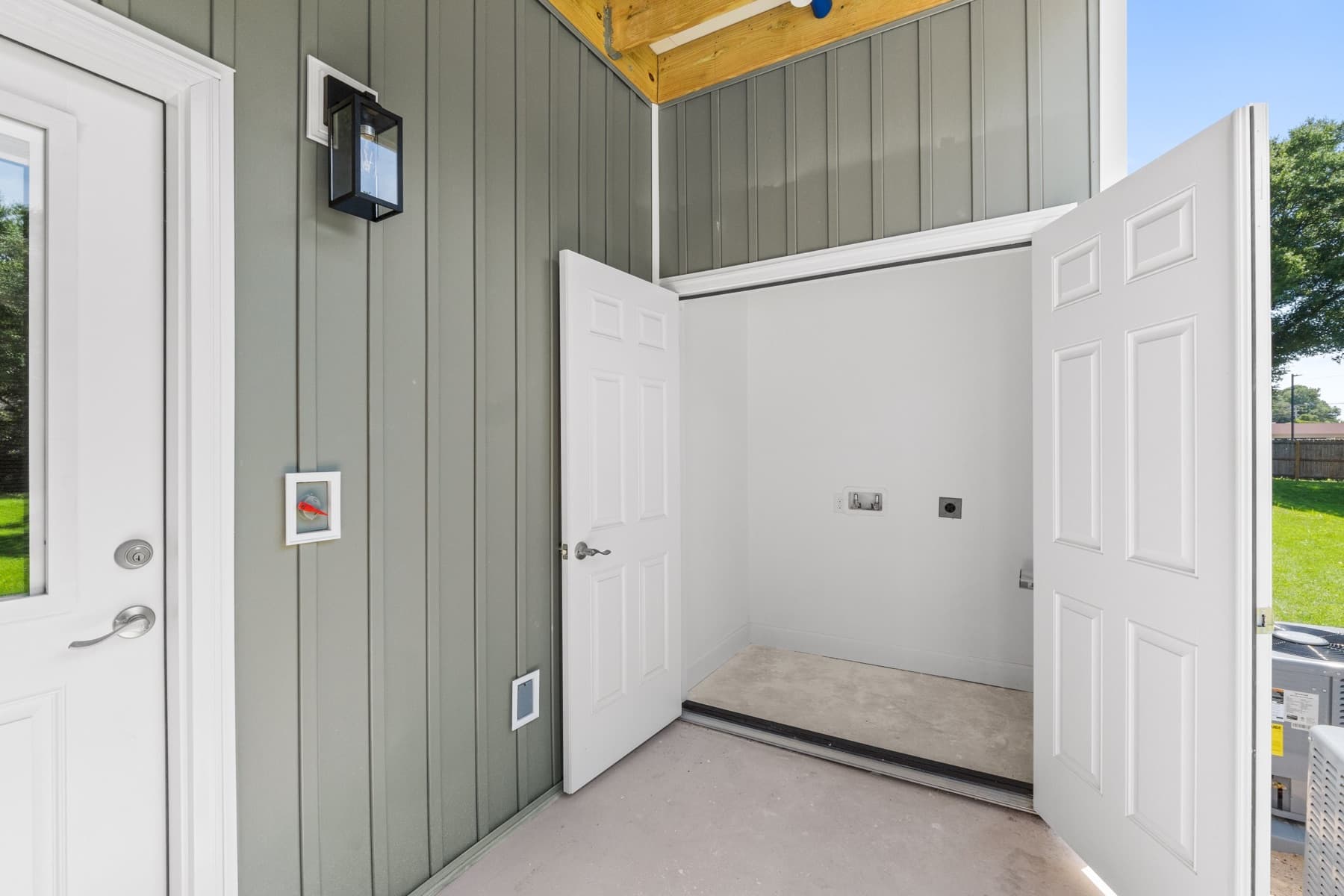 Exterior utility closet with washer and dryer hookups on a new apartment building constructed by Whitrock Associates in Northwest Florida