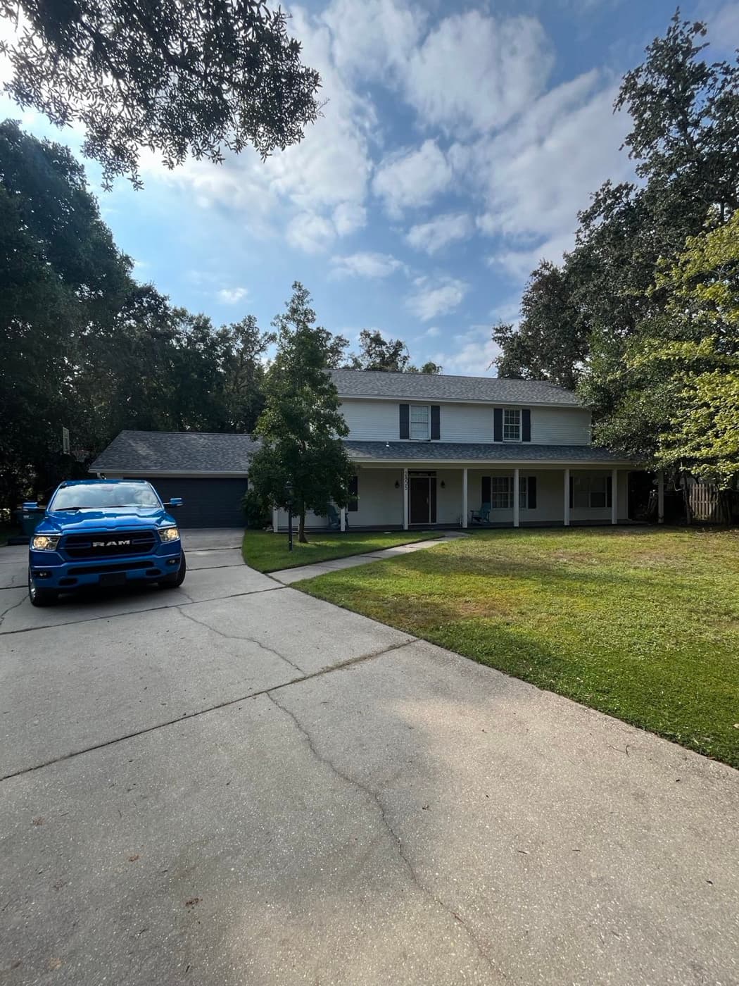 Whitrock Associates truck at a completed Pace, FL roofing project