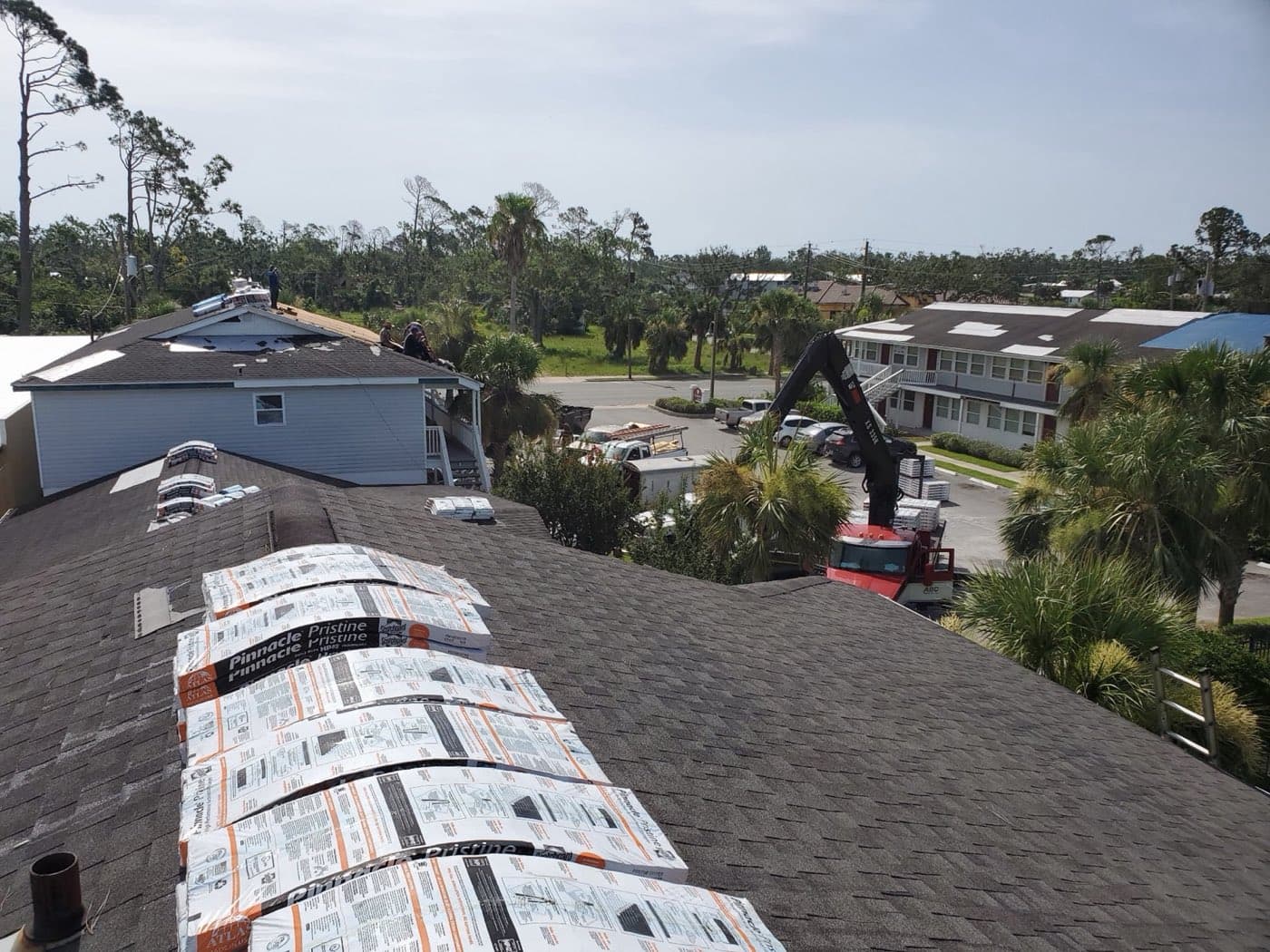 Commercial reroof materials staged on a Panama City Beach, FL building by Whitrock Associates