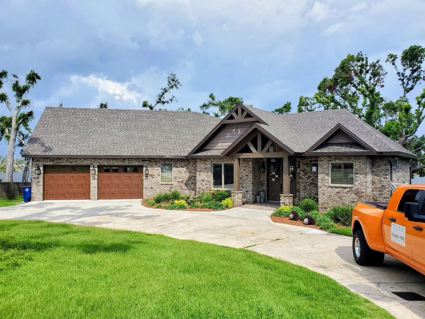 Whitrock Associates truck at a completed Gulf Breeze, FL roofing project