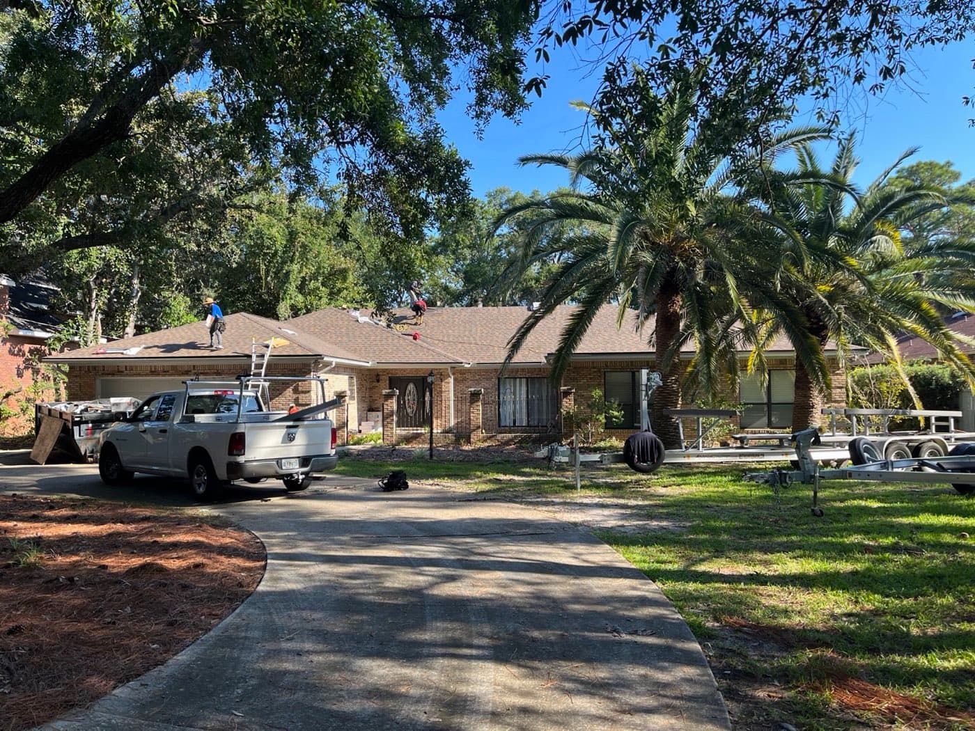 Roofers working on a coastal Mary Esther, FL home