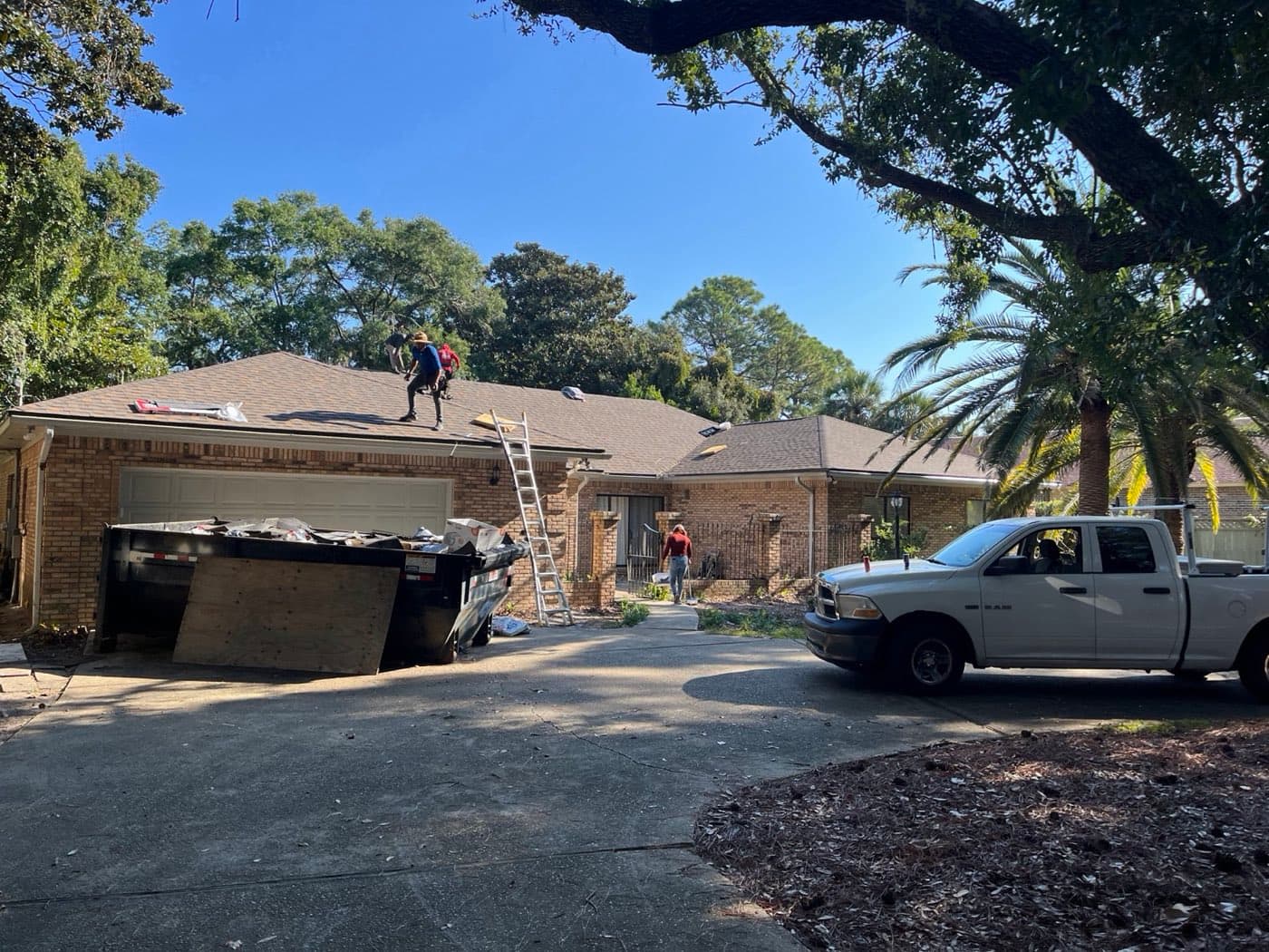 Whitrock Associates crew replacing a residential roof in Northwest Florida