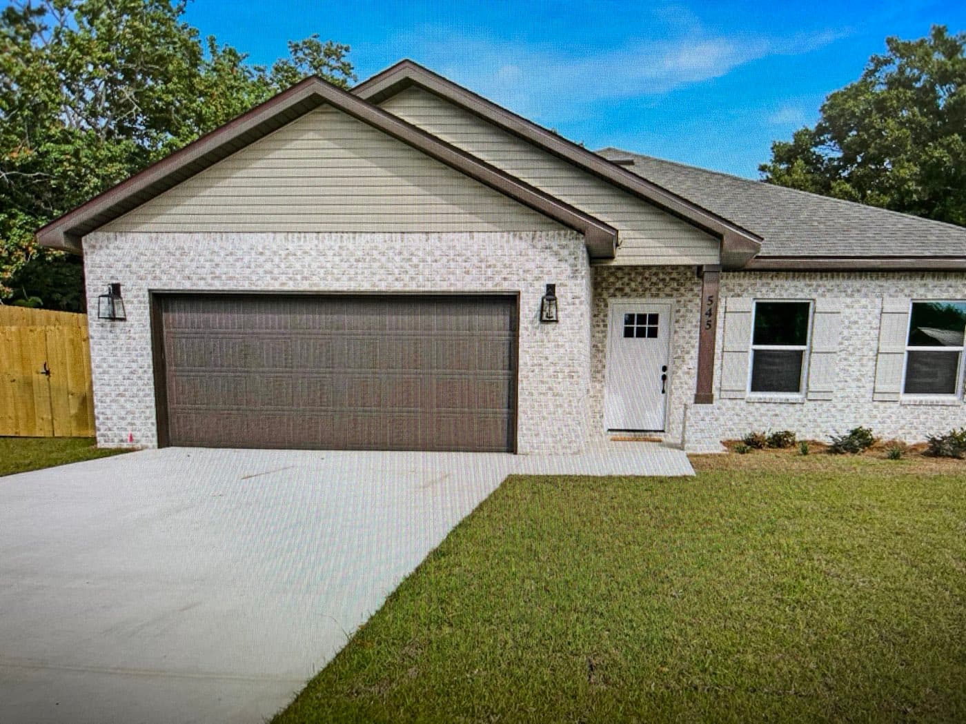 New architectural shingle roof on a new-construction brick home in Navarre, FL by Whitrock Associates