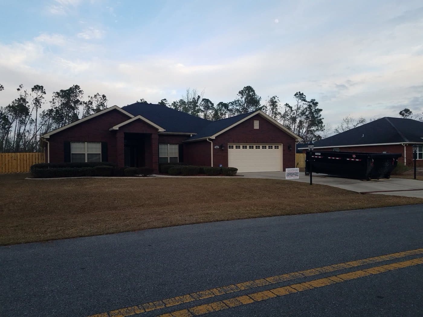 Brick ranch with a new dark shingle roof in Pace, FL by Whitrock Associates