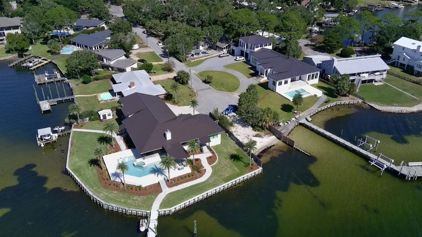 Aerial view of a waterfront Destin, FL home with a new architectural shingle roof by Whitrock Associates