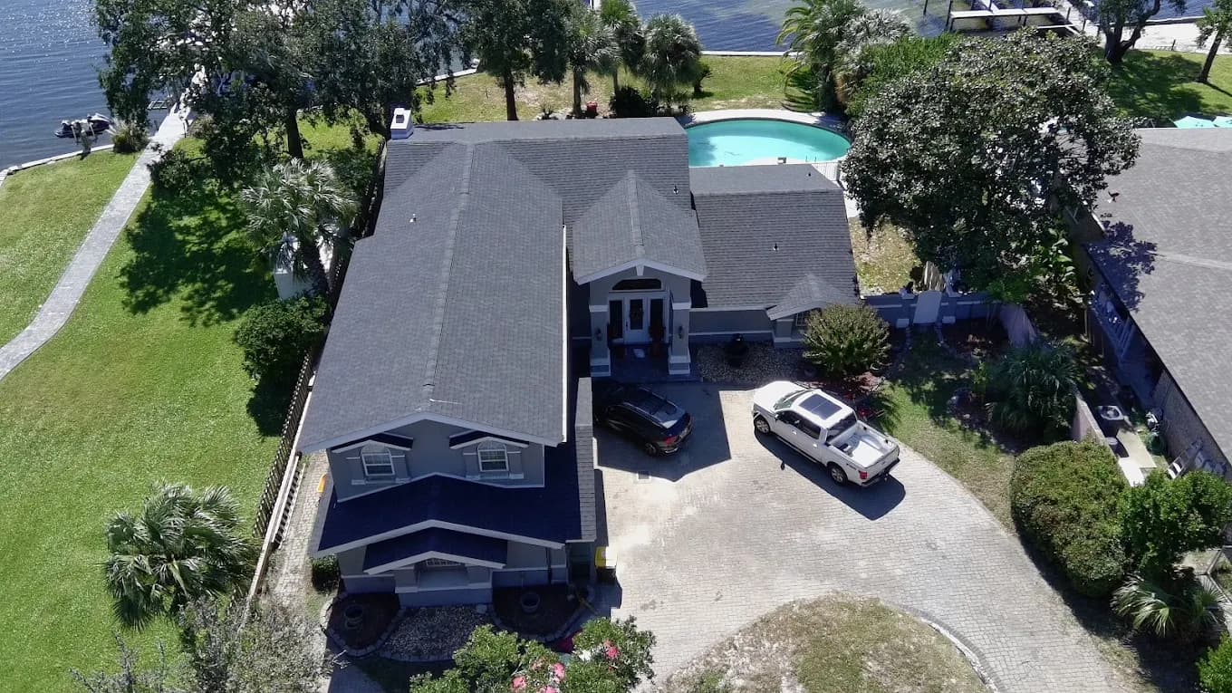 Waterfront Gulf Breeze, FL home with a new dark shingle roof by Whitrock Associates